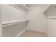 A functional walk-in closet, featuring built-in shelving and rods, offers efficient storage solutions at 4901 W Augusta Cir, Glendale, AZ 85308
