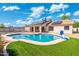 Spacious backyard featuring a sparkling pool and a well-maintained lawn for outdoor activities at 5115 W Kings Ave, Glendale, AZ 85306