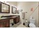Primary bathroom featuring dual sinks, granite countertops, and tiled flooring at 5115 W Kings Ave, Glendale, AZ 85306