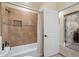 Bathroom with neutral tile, shower-tub combo and decorated door at 5115 W Kings Ave, Glendale, AZ 85306