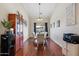 Elegant dining room with hardwood floors, modern chandelier, and glass-top table at 5115 W Kings Ave, Glendale, AZ 85306