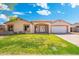 Charming single-story home with a well-manicured lawn and a welcoming front entrance with an arched entryway at 5115 W Kings Ave, Glendale, AZ 85306