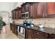The Kitchen boasts stainless steel appliances and elegant dark wood cabinets at 5115 W Kings Ave, Glendale, AZ 85306