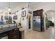 Open-concept kitchen with granite countertops, tile floors, stainless steel appliances, and ample storage at 5115 W Kings Ave, Glendale, AZ 85306