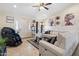 Inviting living room with tile flooring, a contemporary leather sofa, and stylish decor at 5115 W Kings Ave, Glendale, AZ 85306