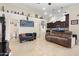 View of the open living area showing tile floors, furnishings, and seamless flow to kitchen and hallway at 5115 W Kings Ave, Glendale, AZ 85306