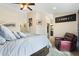 Spacious main bedroom features a reading chair, ensuite bathroom and walk-in closet at 5115 W Kings Ave, Glendale, AZ 85306