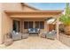 Outdoor patio with comfortable seating, overhead covering, and travertine flooring at 6112 N Almanza Ln, Litchfield Park, AZ 85340