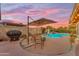 Inviting backyard pool area with covered patio and desert landscaping, perfect for outdoor entertaining at 6126 W Sweetwater Ave, Glendale, AZ 85304