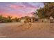 Charming single-story home featuring a brick facade, two-car garage, and desert landscaping at 6126 W Sweetwater Ave, Glendale, AZ 85304
