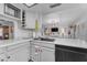 Light and airy kitchen with white countertops and view to the living area at 6126 W Sweetwater Ave, Glendale, AZ 85304