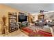 Comfortable living room featuring a large TV, stylish shelving, and neutral decor at 6126 W Sweetwater Ave, Glendale, AZ 85304