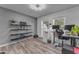 Home office with wood-look floors, grey walls, and ample natural light at 6126 W Sweetwater Ave, Glendale, AZ 85304