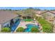 Aerial view of a backyard with a pool, outdoor kitchen, fireplace, mature trees, and lush landscaping at 722 W Claremont St, Phoenix, AZ 85013