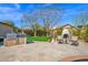 Outdoor kitchen and fireplace with seating area on the large patio, ideal for entertaining at 722 W Claremont St, Phoenix, AZ 85013