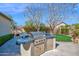 Backyard featuring a built-in grill, tiled countertops, mini fridge, and ample cooking space perfect for outdoor entertaining at 722 W Claremont St, Phoenix, AZ 85013