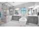 Luxurious bathroom with a soaking tub, dual vanities, marble accents, and a glass-enclosed shower at 722 W Claremont St, Phoenix, AZ 85013