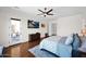 Bright bedroom with hardwood floors, a ceiling fan, patio access, and a dresser providing ample storage at 722 W Claremont St, Phoenix, AZ 85013
