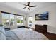 Bright bedroom featuring hardwood floors, a ceiling fan, a view of the backyard, and a door to the patio at 722 W Claremont St, Phoenix, AZ 85013