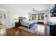 Spacious bedroom with hardwood floors, a large window, ceiling fan, and neutral decor creating a relaxing ambiance at 722 W Claremont St, Phoenix, AZ 85013