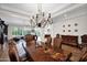 Formal dining room with a grand chandelier and views into the living room and kitchen at 722 W Claremont St, Phoenix, AZ 85013