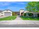 Charming single-story home with manicured lawn, beautiful landscaping, and a brick walkway leading to the entrance at 722 W Claremont St, Phoenix, AZ 85013