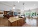 Bright, open kitchen featuring a center island, stainless steel appliances, and seamless flow into the living and dining areas at 722 W Claremont St, Phoenix, AZ 85013