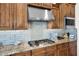 Updated kitchen with stainless steel appliances, granite countertops, stylish tile backsplash and wood cabinetry at 722 W Claremont St, Phoenix, AZ 85013