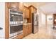 Gourmet kitchen with stainless steel appliances, double ovens, and custom wood cabinetry at 722 W Claremont St, Phoenix, AZ 85013