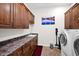 Functional laundry room with washer, dryer, utility sink, counter space, and ample storage cabinets at 722 W Claremont St, Phoenix, AZ 85013