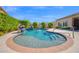 Inviting backyard oasis featuring a sparkling pool with a sun shelf and lush landscaping for ultimate relaxation at 722 W Claremont St, Phoenix, AZ 85013