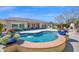 Stunning backyard featuring a beautiful pool, fountain, built-in grill, and ample patio space for outdoor entertaining at 722 W Claremont St, Phoenix, AZ 85013