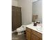 A clean bathroom featuring a modern toilet, sink with storage, and a shower with a neutral-toned curtain at 7318 E Woodsage Ln, Scottsdale, AZ 85258