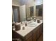 Neutral bathroom with double mirrors, vanity and decorative accents at 7318 E Woodsage Ln, Scottsdale, AZ 85258