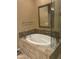 Elegant bathroom features a large soaking tub with stone tile surround and glass enclosed shower at 7318 E Woodsage Ln, Scottsdale, AZ 85258
