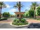 Secure gated entrance to the community boasts mature palm trees and landscaping for an upscale feel at 7318 E Woodsage Ln, Scottsdale, AZ 85258