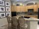 Charming kitchen featuring granite countertops, a breakfast bar, and decorative elements at 7318 E Woodsage Ln, Scottsdale, AZ 85258