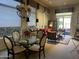 Sunlit living area with a dining table, red couch, neutral tones, and window shades for a relaxing atmosphere at 7318 E Woodsage Ln, Scottsdale, AZ 85258