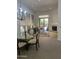 Open-concept living room with fireplace, glass table, and sliding glass doors to the outdoor space at 7318 E Woodsage Ln, Scottsdale, AZ 85258