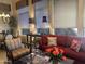 Comfortable living room features a red sofa, decorative pillows, ambient lighting, and stylish decor at 7318 E Woodsage Ln, Scottsdale, AZ 85258