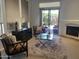 Open living room showcasing a fireplace, sliding glass doors, and comfortable seating at 7318 E Woodsage Ln, Scottsdale, AZ 85258