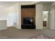 Living area featuring a built-in entertainment center, a door to a bathroom, and neutral colored walls at 7318 E Woodsage Ln, Scottsdale, AZ 85258