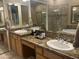 Luxurious bathroom with dual sinks, granite counters, and a glass-enclosed shower at 7318 E Woodsage Ln, Scottsdale, AZ 85258