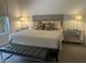 Inviting main bedroom features a plush king bed, mirrored bedside tables, and a leather bench at 7318 E Woodsage Ln, Scottsdale, AZ 85258