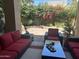 Cozy outdoor patio with comfortable seating surrounded by lush greenery and flowering plants at 7318 E Woodsage Ln, Scottsdale, AZ 85258