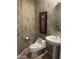 Elegant powder room with a pedestal sink, a framed mirror, and stylish accents at 7318 E Woodsage Ln, Scottsdale, AZ 85258