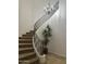 Elegant staircase with decorative iron railing, carpeted steps, and stylish chandelier at 7318 E Woodsage Ln, Scottsdale, AZ 85258