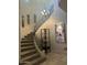 Grand staircase with wrought iron railing and decorative lighting fixture at 7318 E Woodsage Ln, Scottsdale, AZ 85258