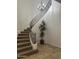 Elegant staircase with decorative iron railing, carpeted steps, and stylish chandelier at 7318 E Woodsage Ln, Scottsdale, AZ 85258