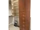 Custom closet with adjustable shelves, drawers, and hanging space, complemented by a handy folding ladder at 7318 E Woodsage Ln, Scottsdale, AZ 85258